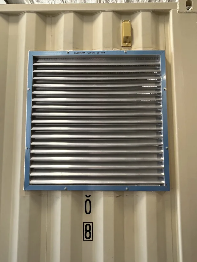 Detail of exhaust port cutout and flashing on a generator container