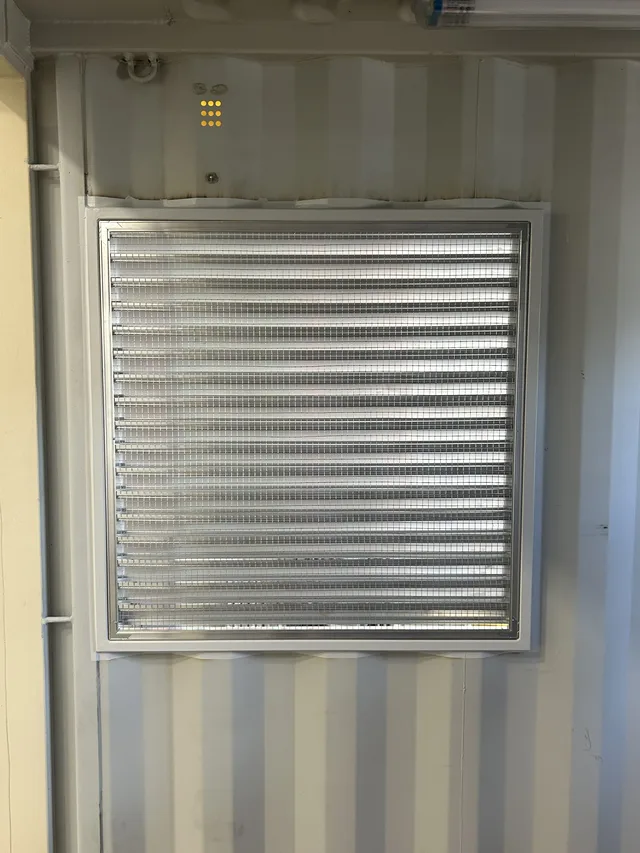 Generator housing unit showing sound barrier wall installation