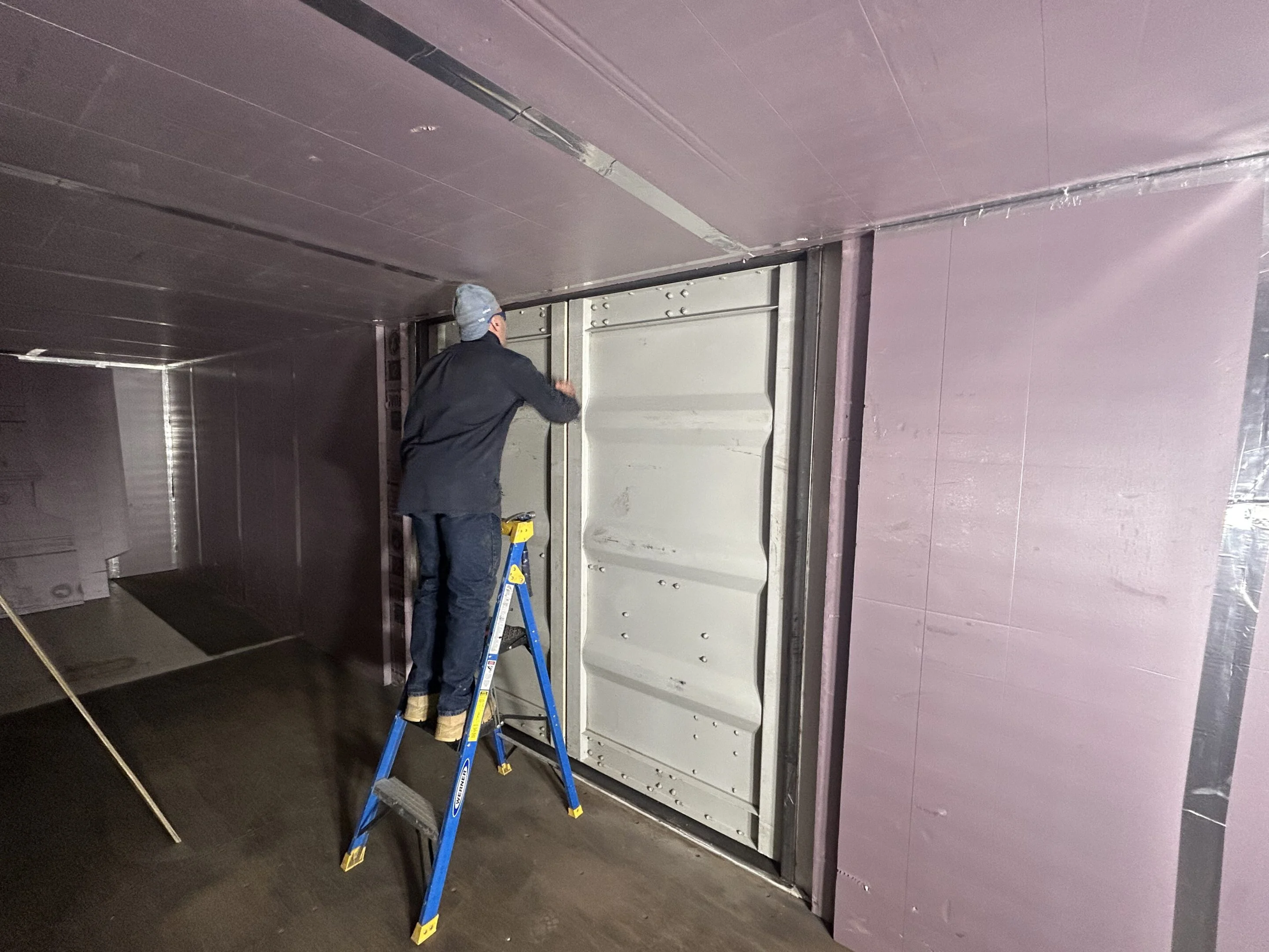 Custom container modification with personnel door installation at Hercules