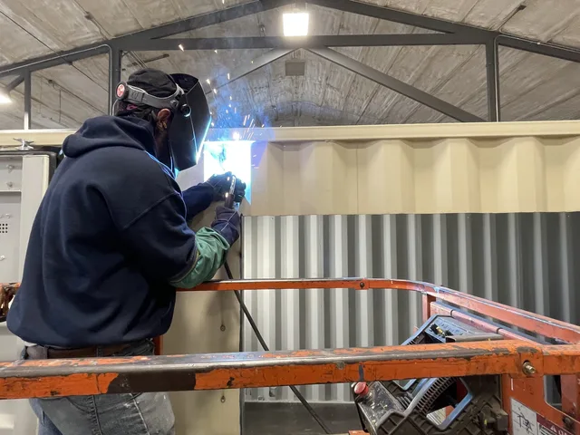 Custom container modification with personnel door installation by Hercules