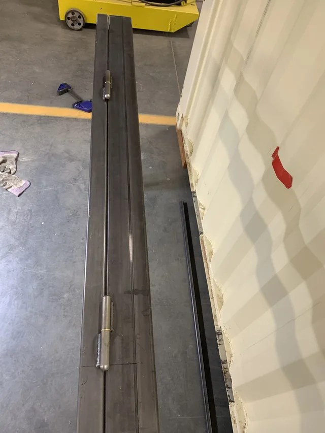 Interior of a completed container modification with vinyl plank flooring