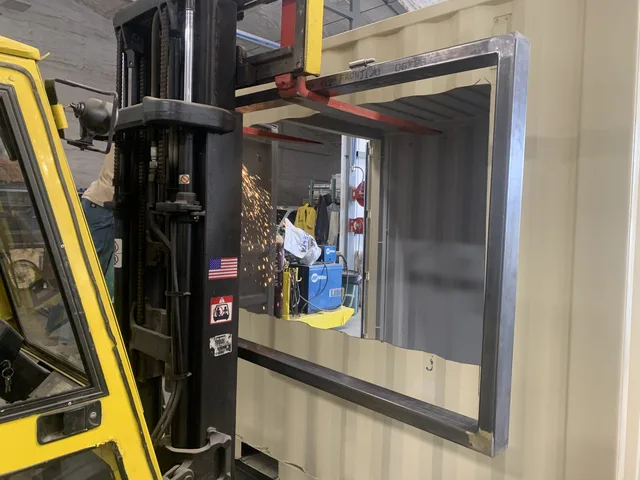 Modified container showing security camera mount and cable routing