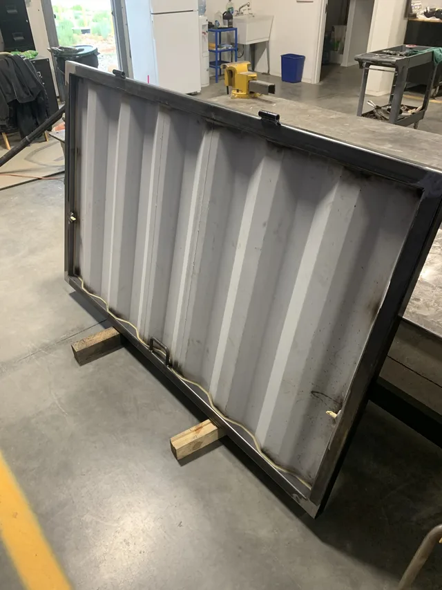 Custom container modification featuring roll-up and man door combo