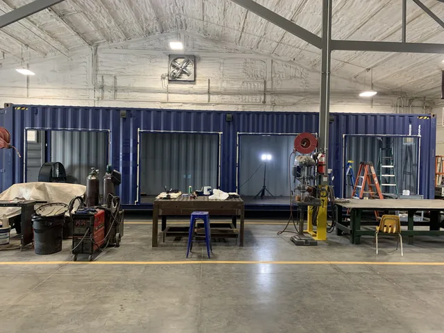 Custom container with pass-through service window installation