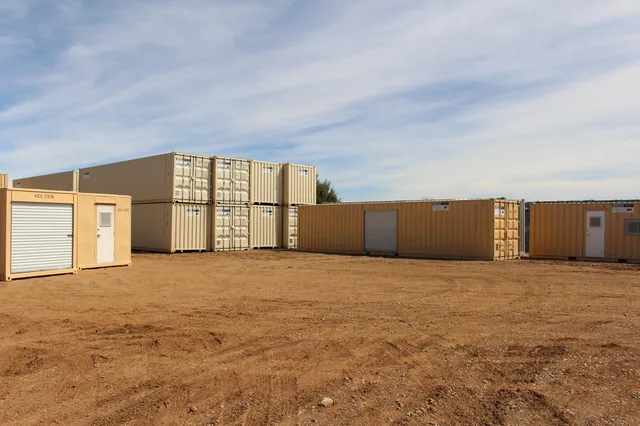 Container positioned under a carport structure for covered storage